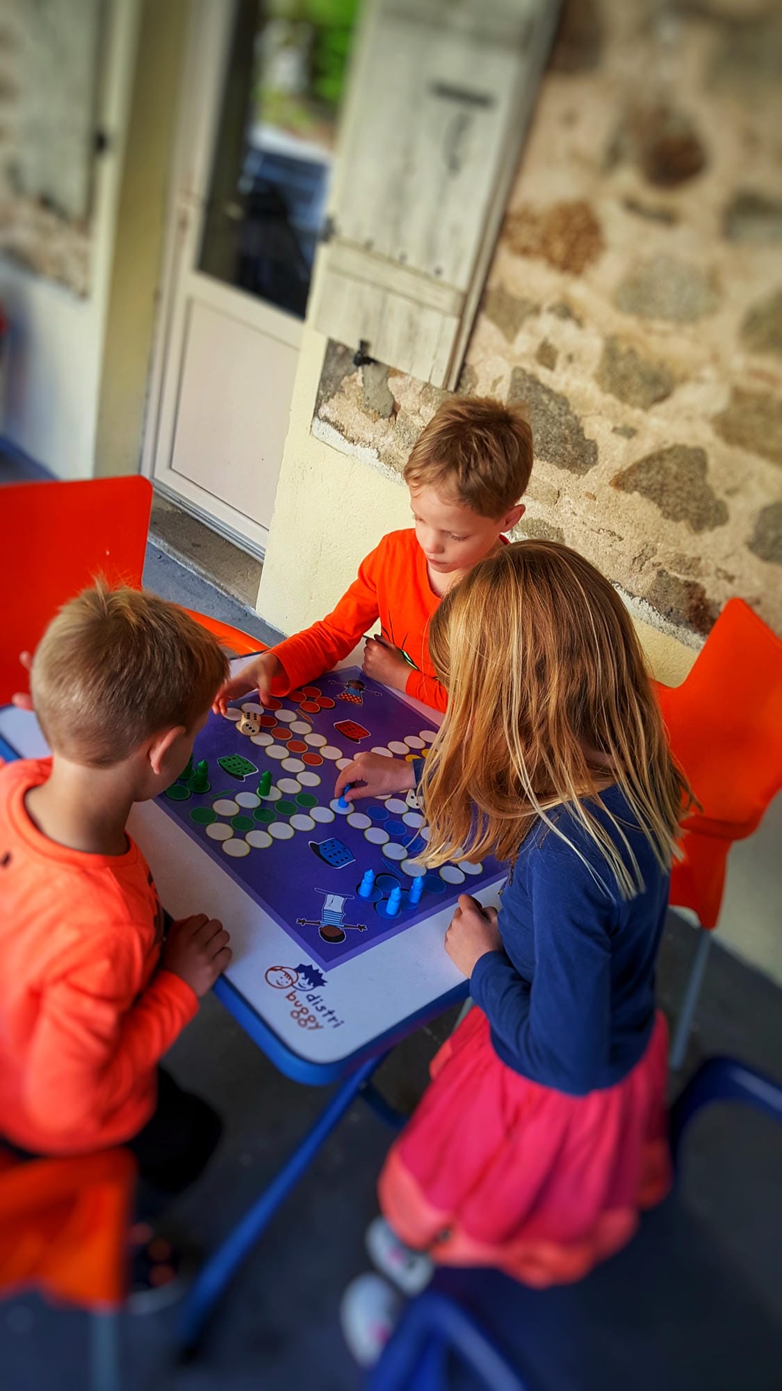 Enfants jouant aux jeux de société dans l'espace animations du camping Château le Verdoyer