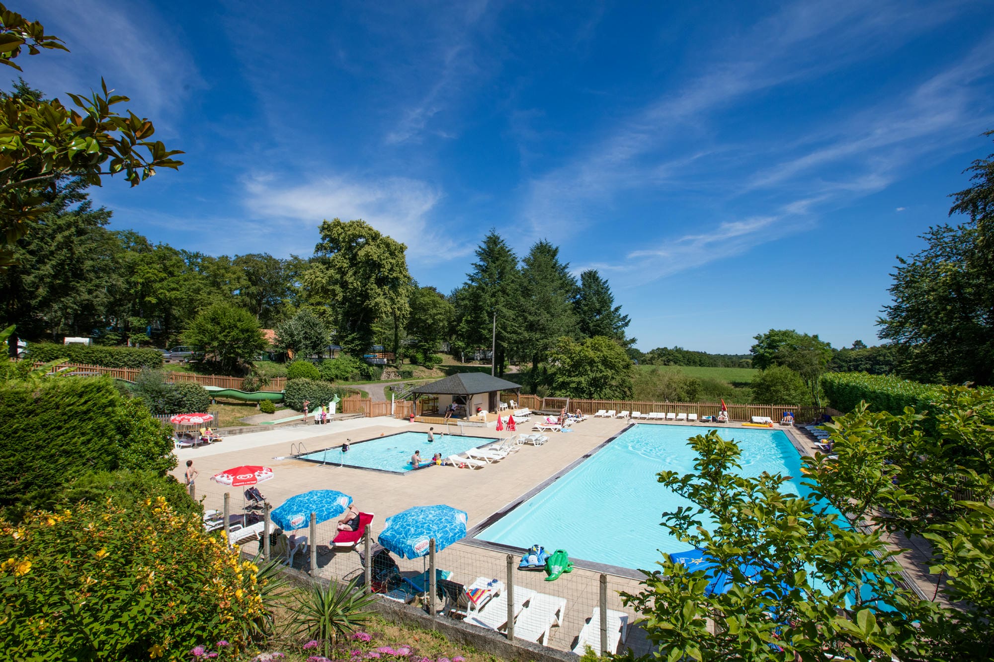 Au soleil à la grande piscine extérieure du Camping Château le Verdoyer