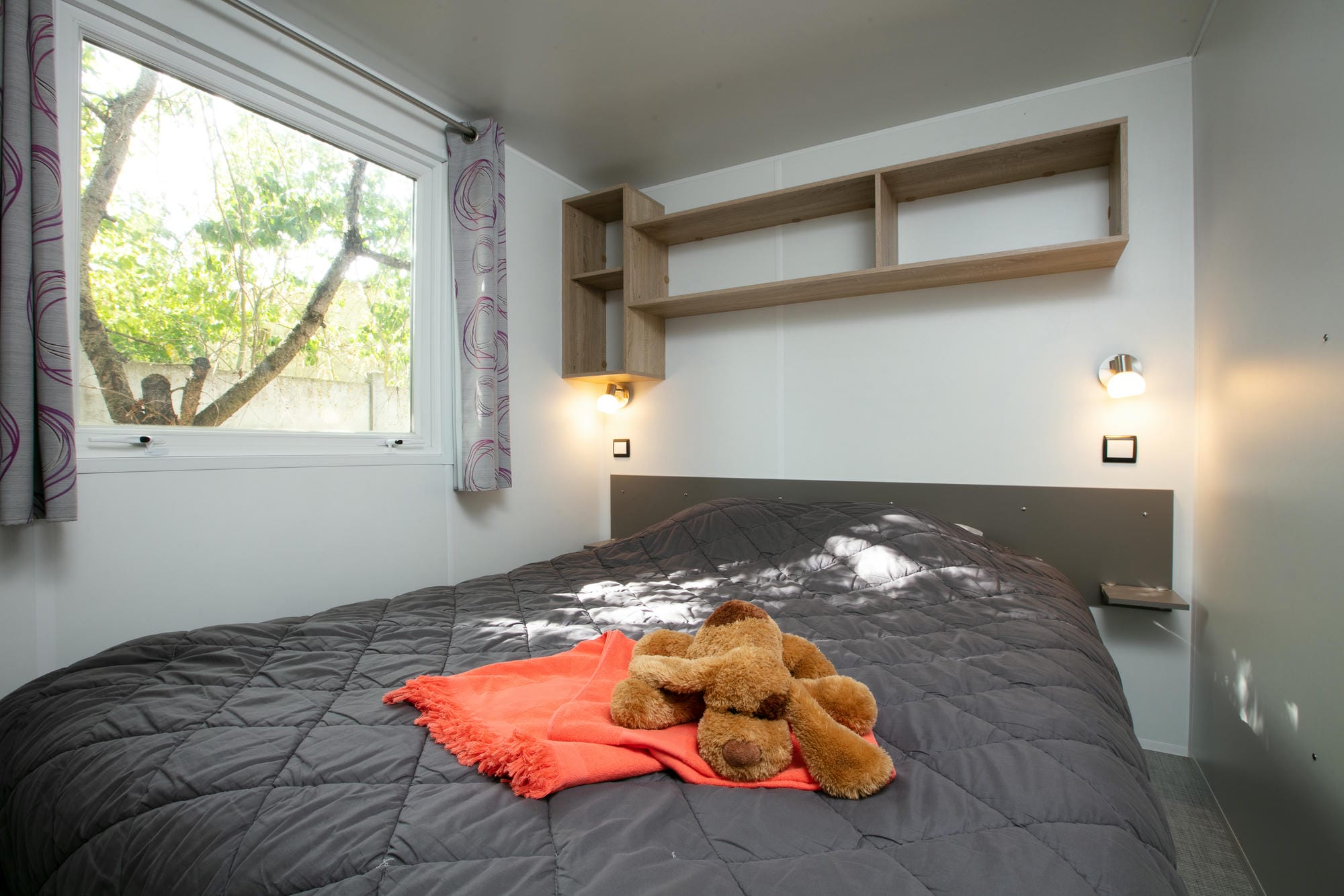 Ours en peluche sur un lit d'enfant dans un mobil-home 3 chambres au Château le Verdoyer