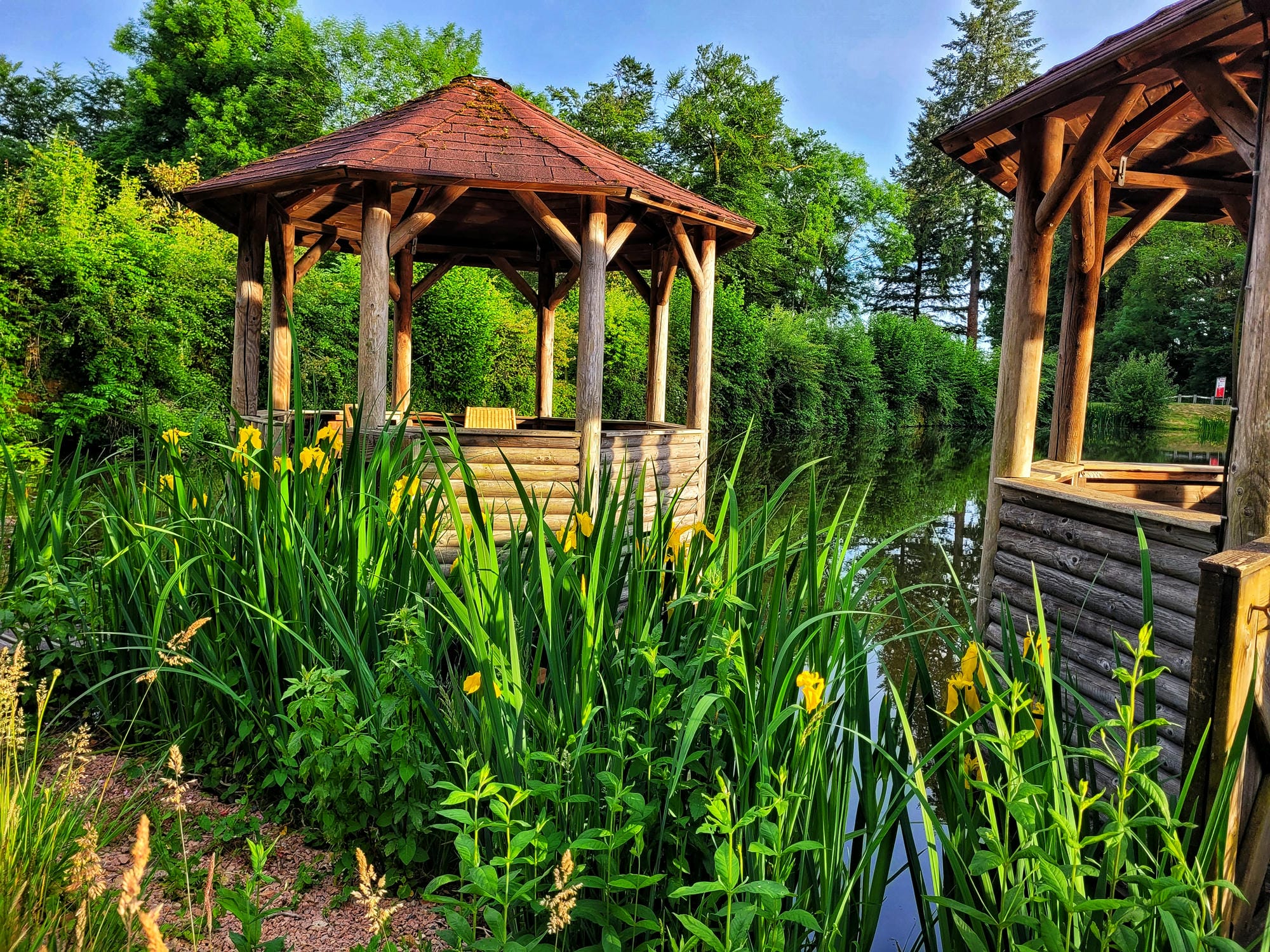 Deux tonnelles installées au bord de l'étang, terrasse du restaurant du Château le Verdoyer