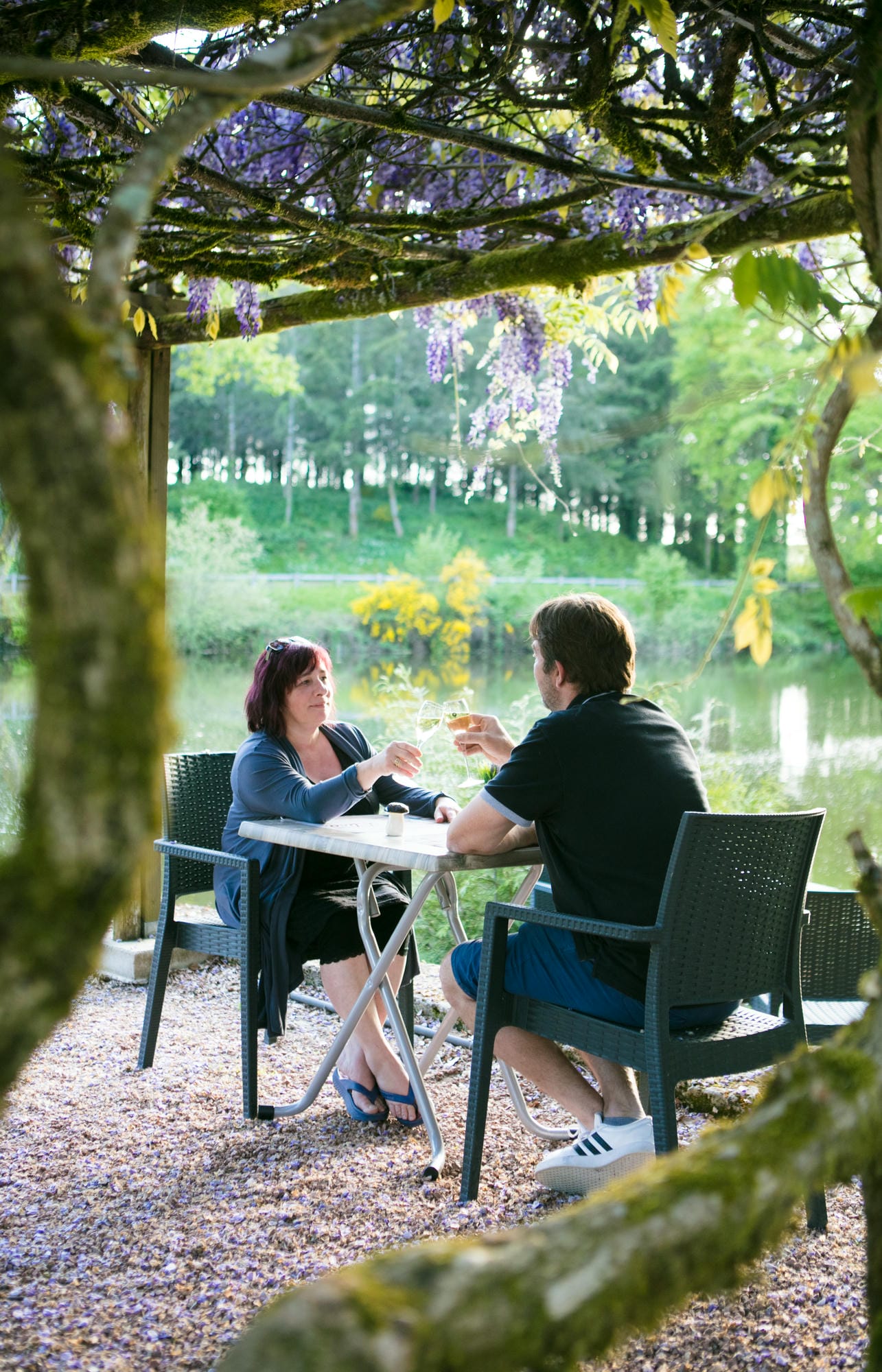 Couple attablé sous la glycine en terrasse du restaurant du Château le Verdoyer