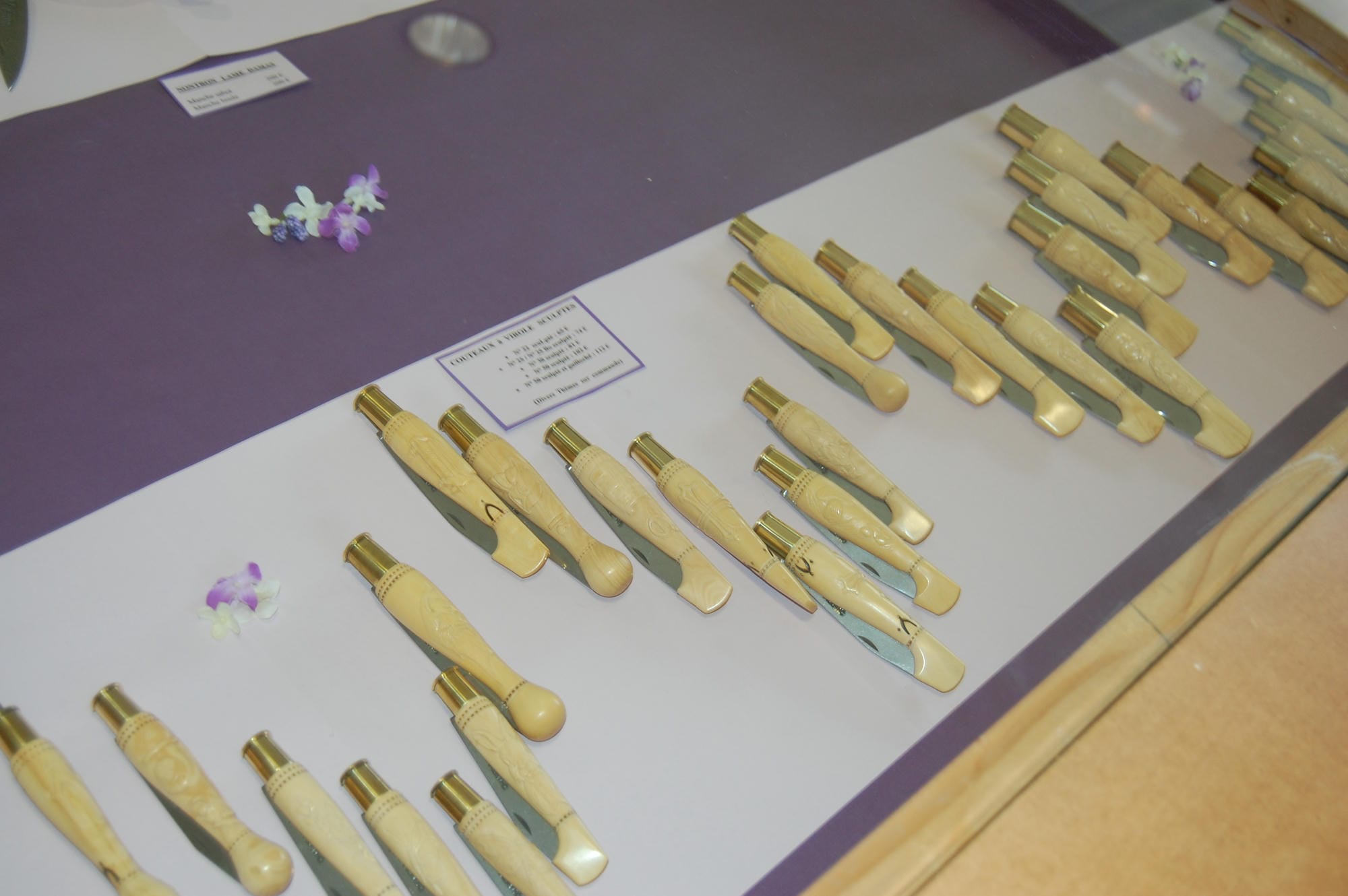 Assortiment de couteaux de Nontron exposés dans une vitrine, savoir-faire du Périgord