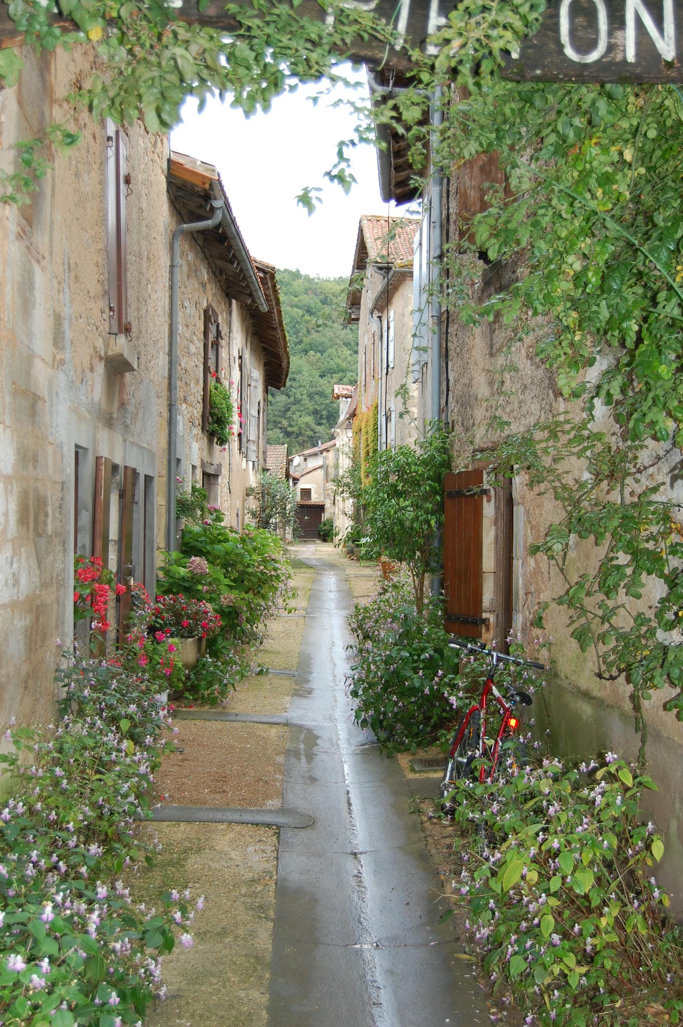 Ruelle pittoresque avec un panneau indicateur à St-Jean-de-Côle
